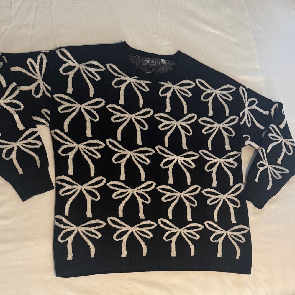 Black and White Sweater with White Bow Design